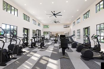 A gym with a variety of equipment including treadmills, stationary bikes, and weight machines at Verity Luxury Apartment Homes Apartments, Florida, 32960